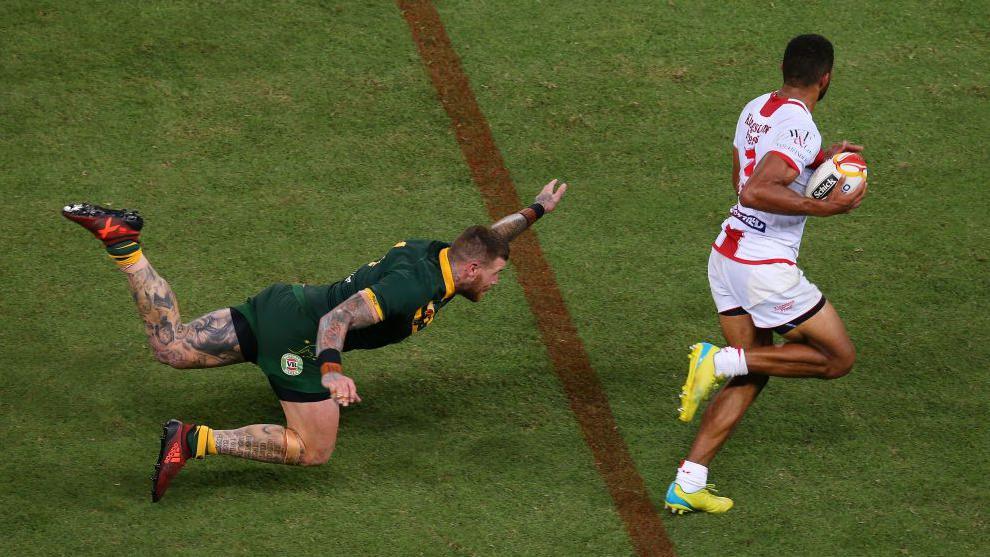 Australia's Josh Duggan ankle taps England's Kallum Watkins