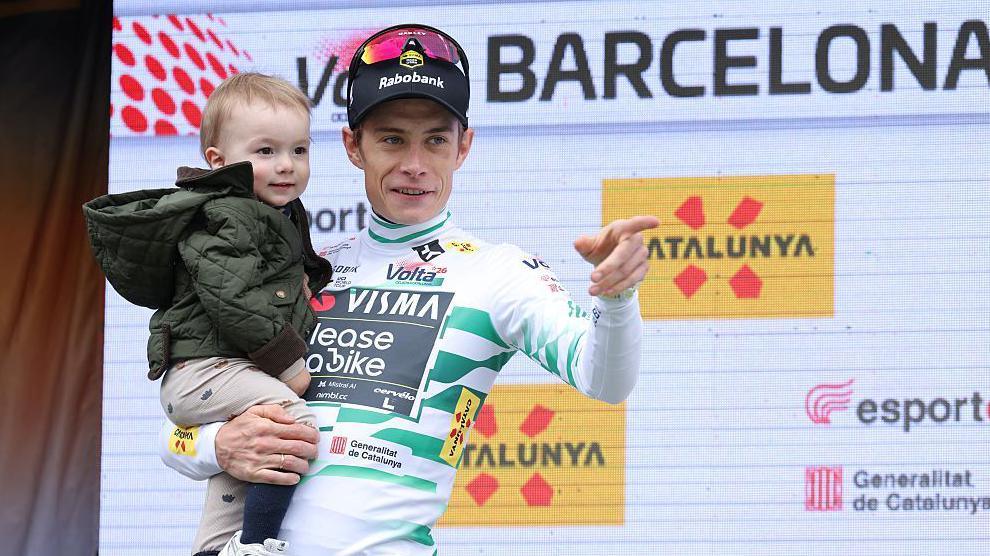 Jonas Vingegaard holds his young son on the podium after his victory