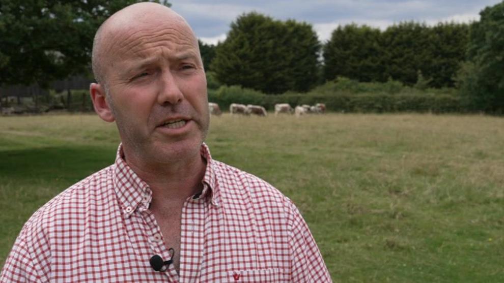 Male farmer dressed in red and white checked shirt