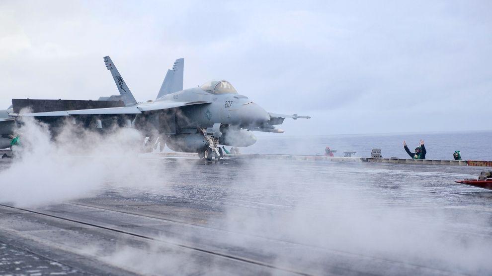 An F/A18 Super Hornet fighters prepares for launch by steam catapult from the USS Carl Vinson