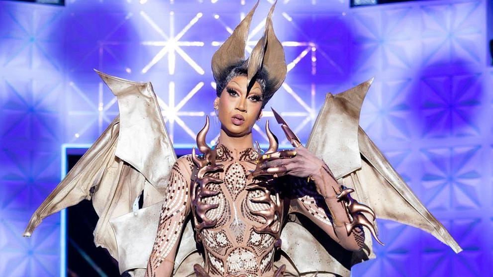 Tia Kofi on the runway for Ru Paul's Drag Race UK vs The World, series two. Tia wears a look inspired by a teradactyl, complete with wings and a spikey bodice.