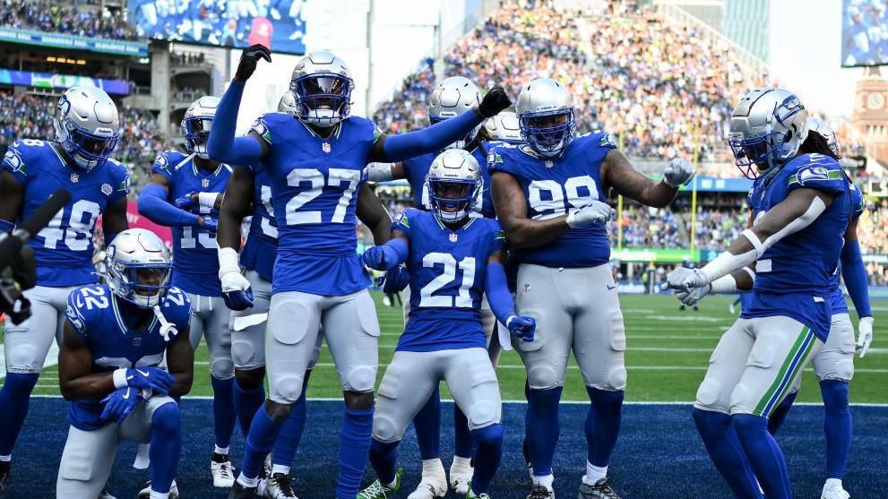 The Seattle Seahawks defence celebrates an interception by Riq Woolen against the Denver Broncos