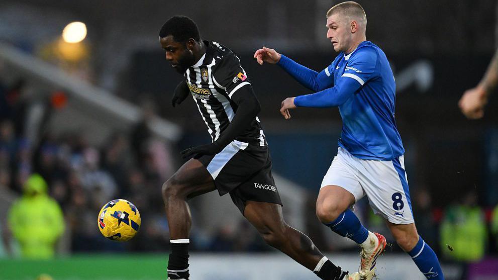 Matthew Dennis dribbles away from Chesterfield's Ryan Stirk