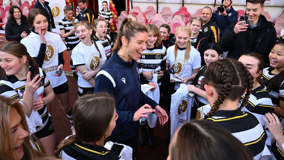 Sarah Hunter with a group of young fans