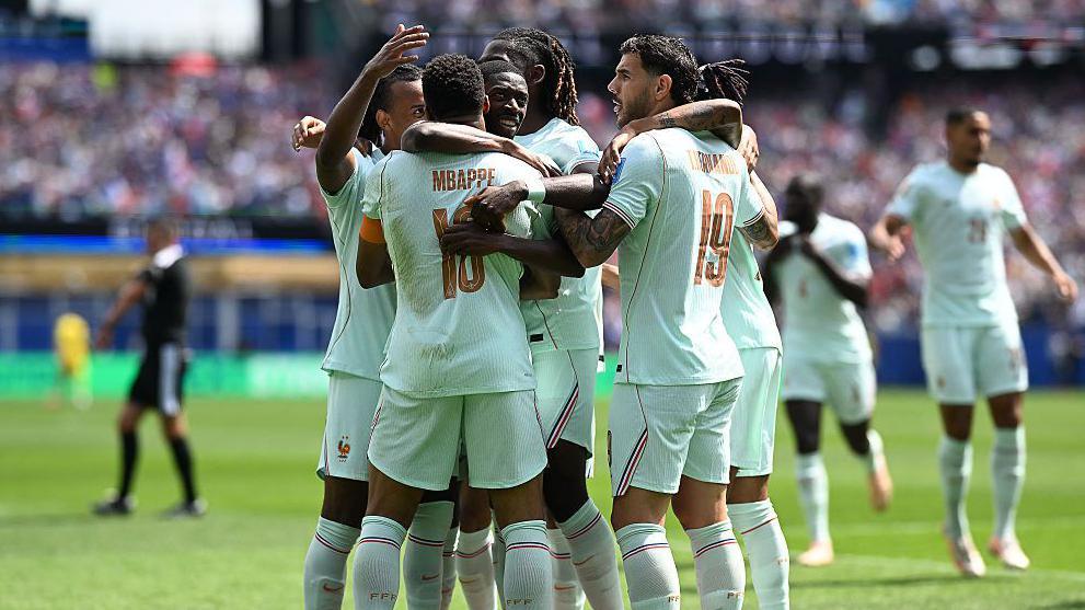 France players embrace after scoring a goal against Norway