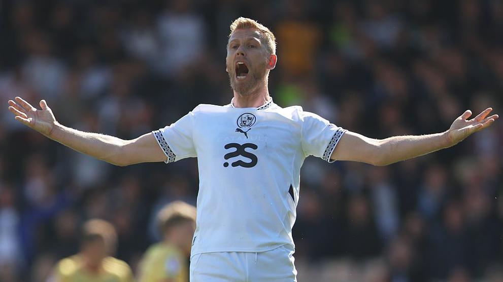 Jayden Stockley throws his arms out and appeals during a match for Port Vale