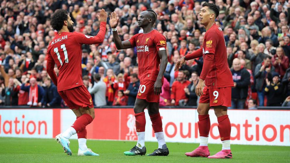 Mo Salah, Sadio Mane and Roberto Firmino celebrating