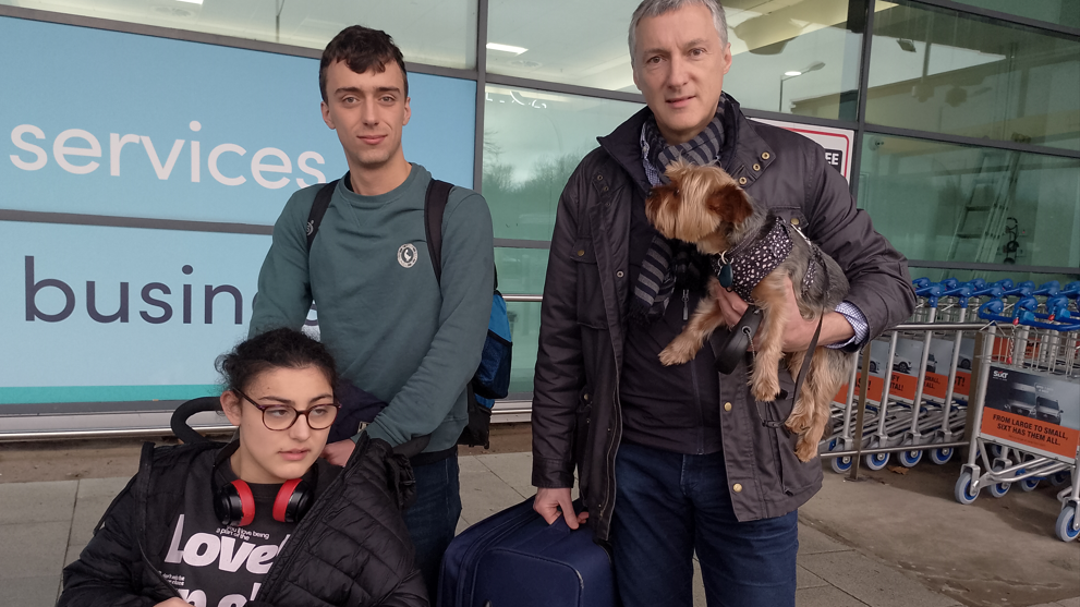 Brian Cummings in brown jacket, James Cummings in green jumper and Carmen Cummings wearing brown jacket with black and red headphones