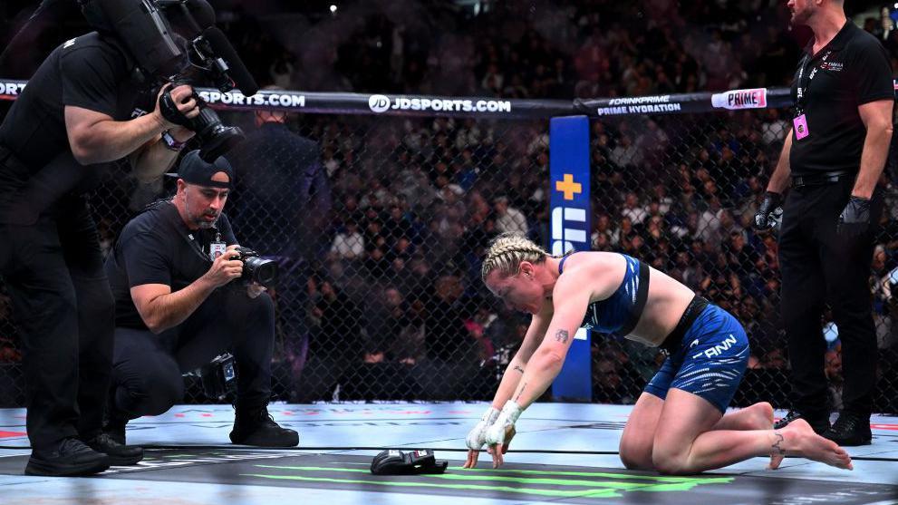 Molly McCann lays her gloves down in the octagon