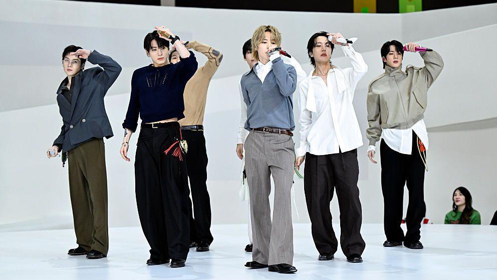 BTS performing on a white stage with a white backdrop.