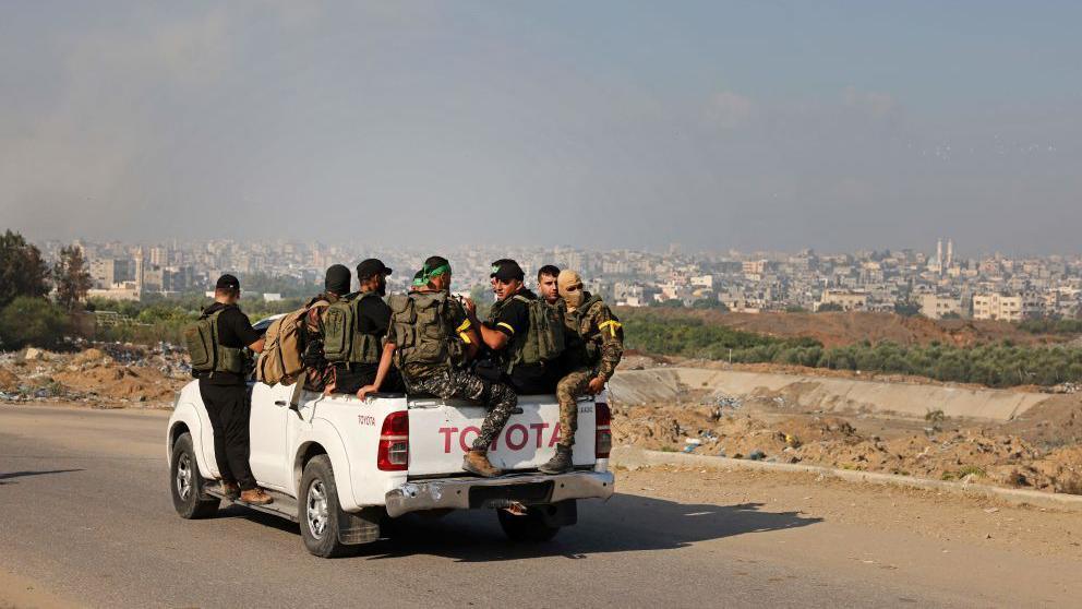 Palestinian militants of the Izzedine al-Qassam Brigades move towards the Erez crossing between Israel and the northern Gaza Strip on October 7, 2023. 