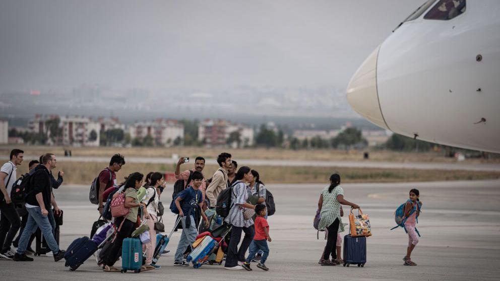 The passengers board another plane that arrived in Erzurum, Turkiye after their Vistara Airlines flight from India to Germany made an emergency landing at Erzurum Airport due to a bomb threat, on September 7, 2024.