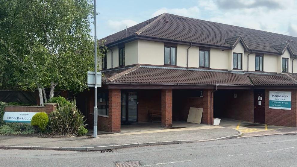 A care home building which is two-storey and red brick.