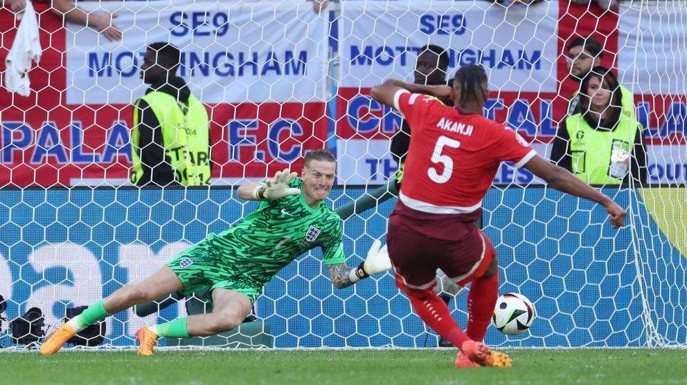 Jordan Pickford saves Manuel Akanji's penalty during England's shootout win over Switzerland at Euro 2024
