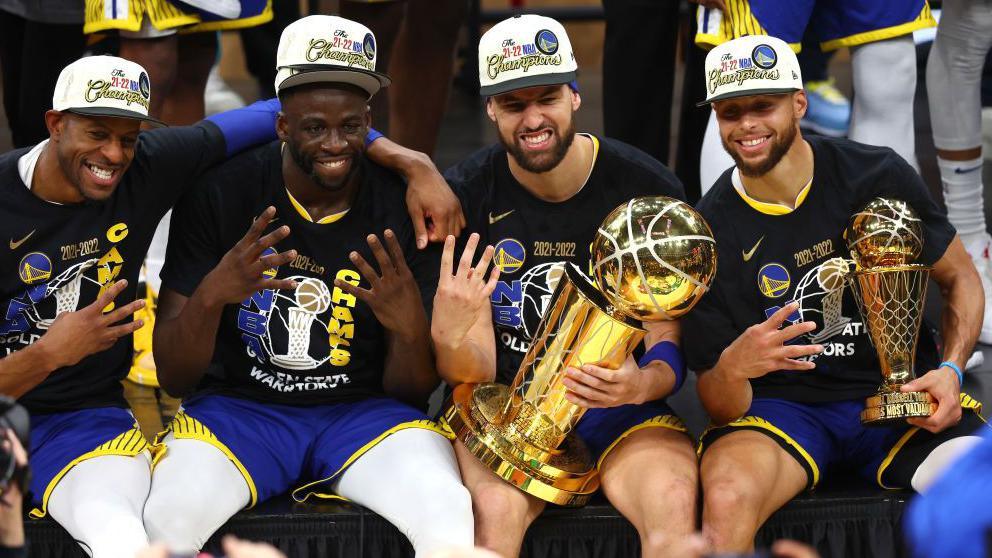 Andre Iguodala, Draymond Green, Klay Thompson and Stephen Curry pose for cameras after all winning a fourth NBA title with the Golden State Warriors in 2022