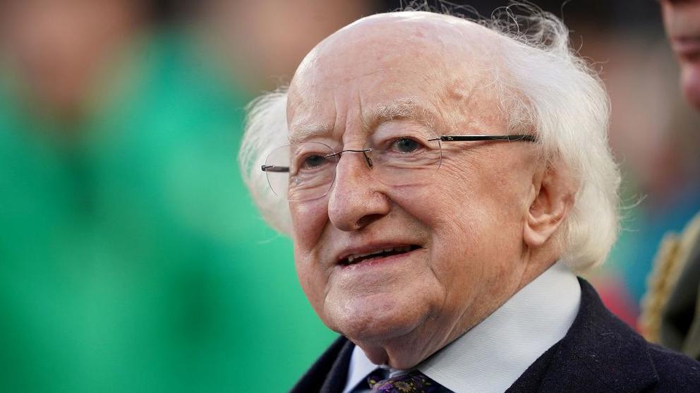 Irish president Michael D Higgins smiling at an Oreland rugby match 