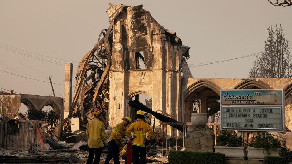 Firefighters work near a church destroyed in the Palisades Fire, in the Pacific Palisades neighborhood in Los Angeles, California, U.S. January 10, 2025.