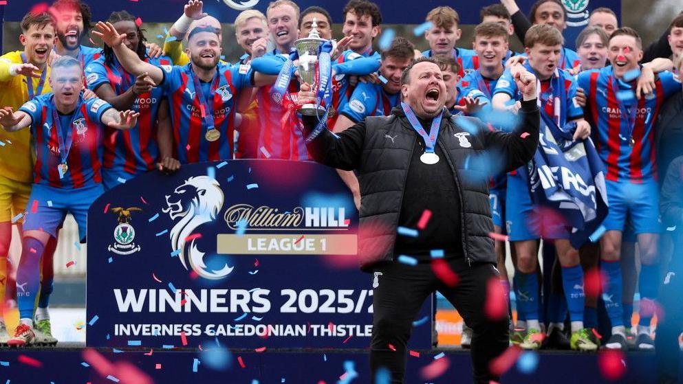 Inverness Caledonian Thistle head coach Scott Kellacher, dressed in black, joins the rest of the team to celebrate the League One win