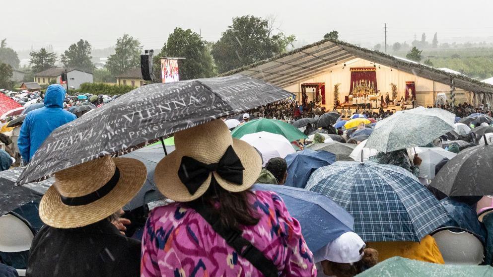 Worshippers stand under umbrellas amidst heavy rain during the episcopal consecration of Catholic priests as part of a pontifical Mass organized by the Society of Saint Pius X in Econe, near Sion, Switzerland, 1 July