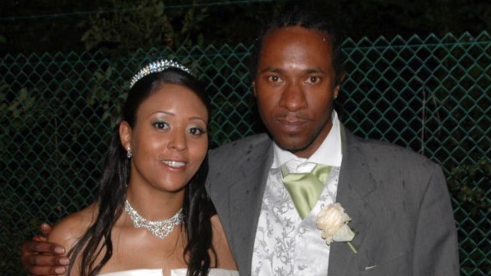 Riccardo Holness with his sister Ramona Marsh, who is wearing a white wedding dress. Mr Holness is wearing a grey suit.