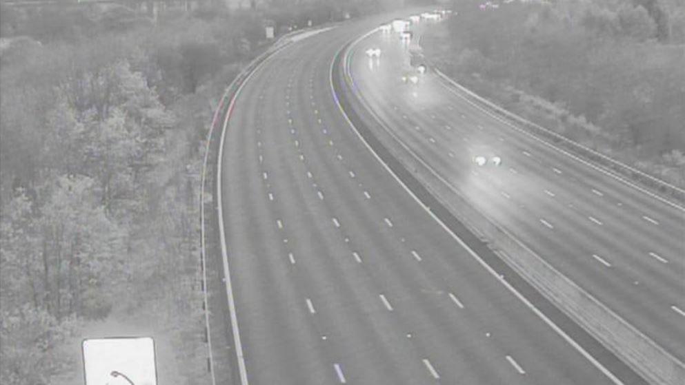 A black and white image showing the closed southbound carriageway with cars seen travelling in the opposite direction