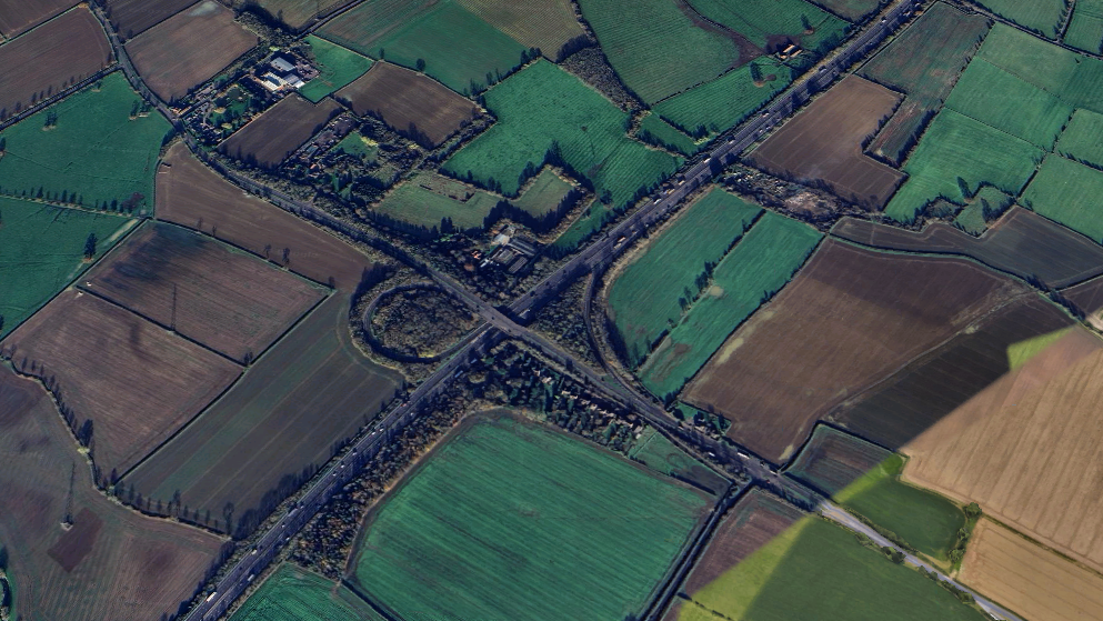 A view of M5 J10 from above showing fields around the side and the roads leading to it