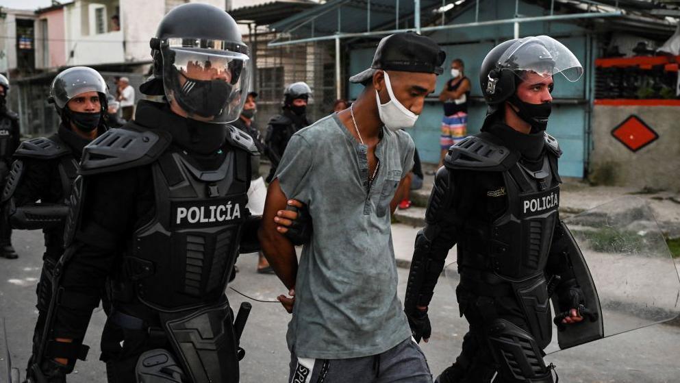 A man is arrested during a demonstration against the government of President Miguel Diaz-Canel in Arroyo Naranjo Municipality, Havana on July 12, 2021. 