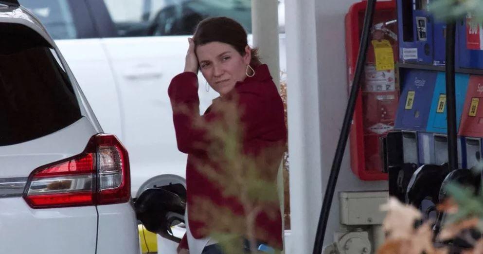 Woman filling up her car 