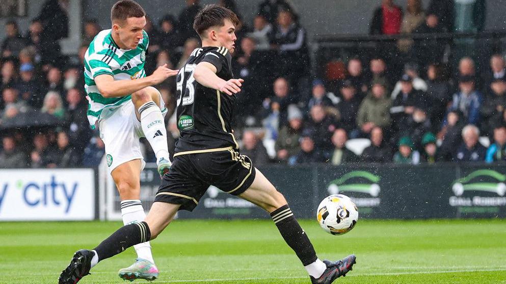 Celtic's Johnny Kenny (left) shoots against Queen's Park
