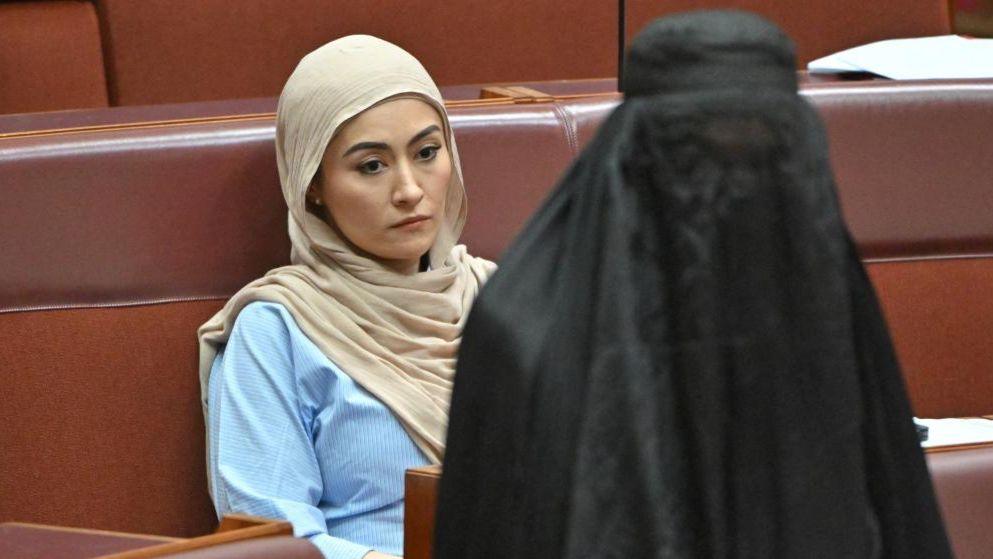 Independent senator Fatima Payman reacts as One Nation leader Pauline Hanson wears a burka in the Australian parliament