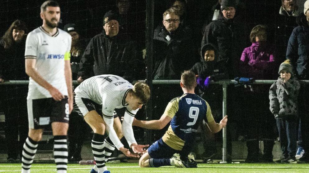 East Kilbride match winner Cameron Elliott slides in celebration