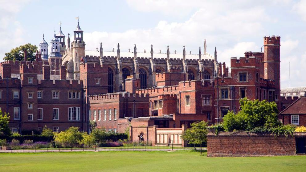 Eton College, in Berkshire, with the college chapel in the distance and a number of red brick Tudor buildings next to it