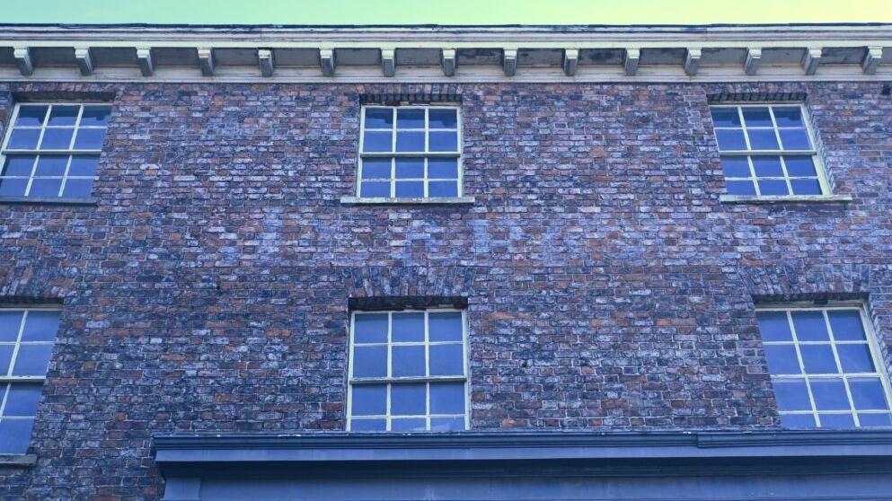 A building wall in Church Street that says in very faded lettering 'W.Mackinder'