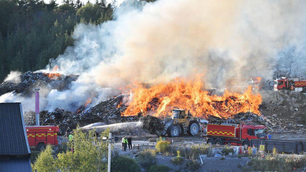 A fire at a landfill is pictured on September 05, 2021 in Botkyrka, south of Stockholm, one of the several places in Sweden that the company "NMT Think Pink" has turned into a garbage dump,