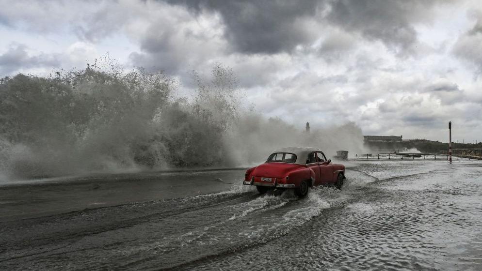 A car driving through storm water in Havana, the Cuban capital