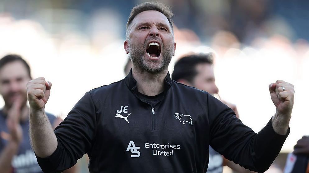 John Eustace celebrates by pumping his fists