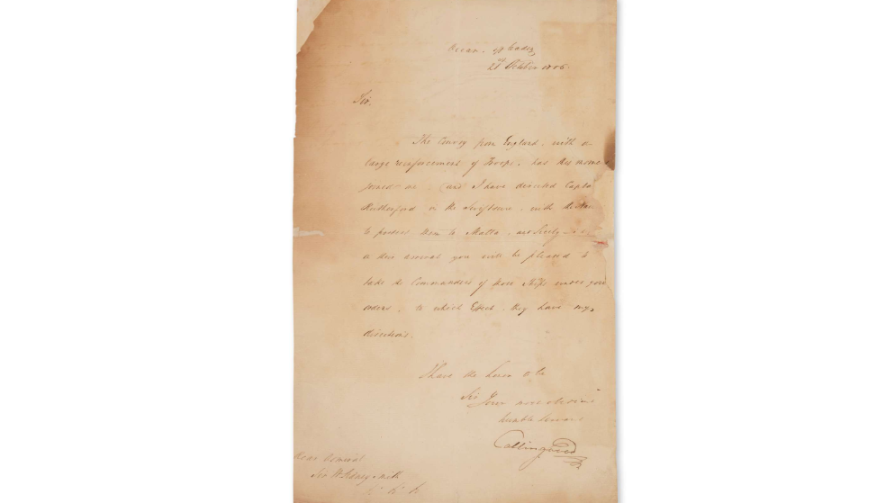 An old letter on brown paper with cursive writing.