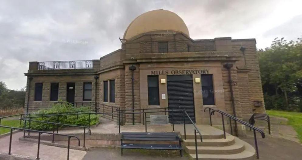 The exterior of Mills Observatory, a large stone building with a dome set in parkland