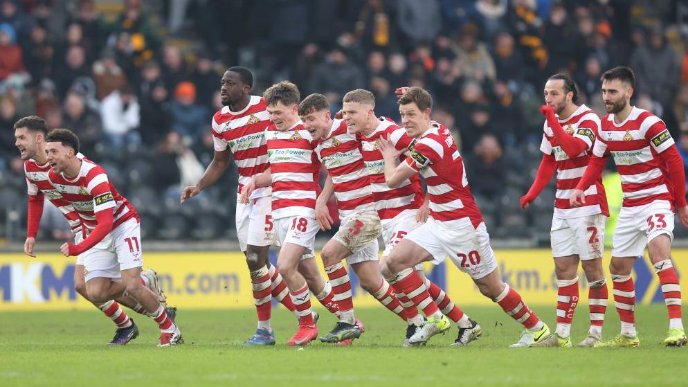 Doncaster celebrate the winning penalty in the shootout