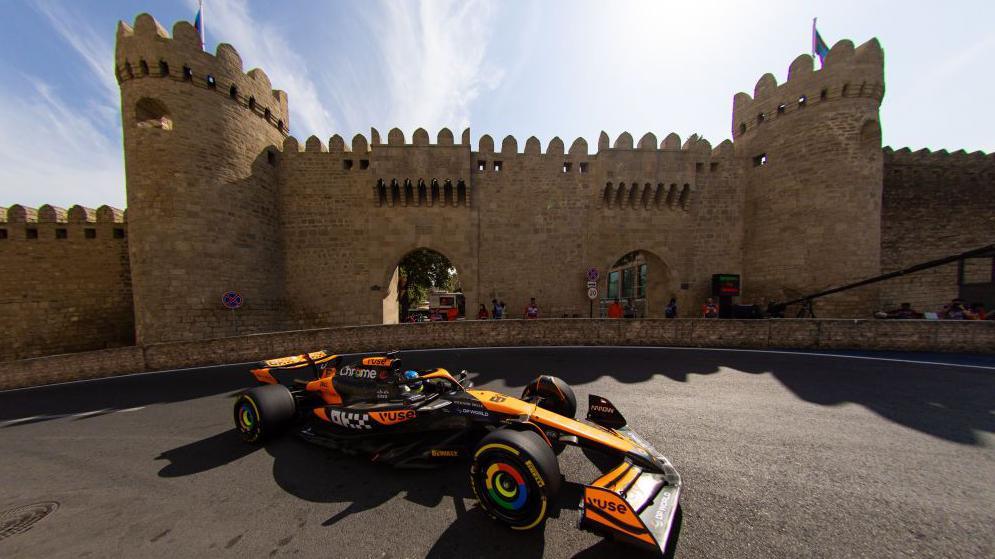 McLaren's Oscar Piastri passes a castle during practice for the 2024 Azerbaijan Grand Prix in Baku