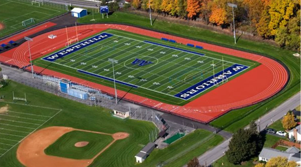 An aerial shot of Westhill High School, showing a football field surrounded by a running track