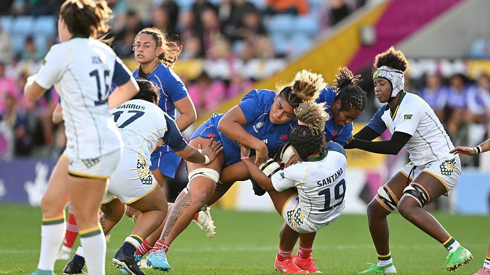 Hina Ikahehegi battles for the ball against Brazil