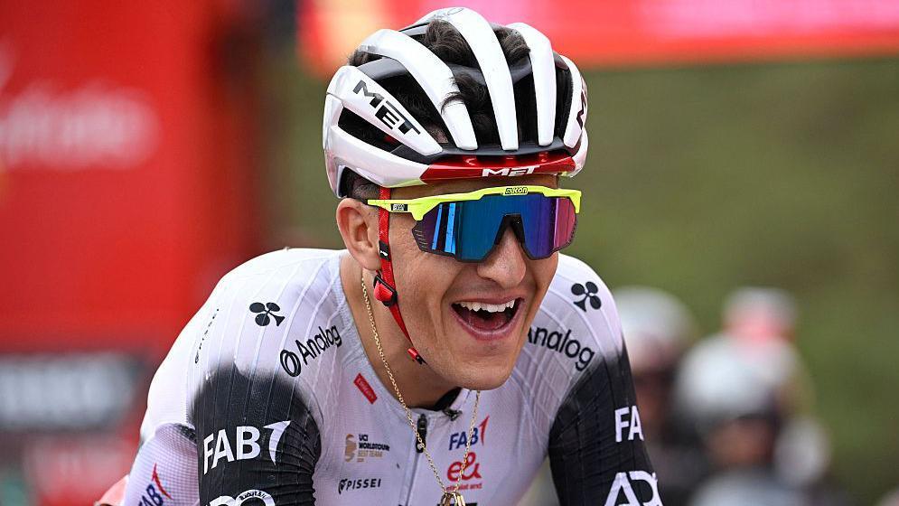 Marc Soler smiles as he crosses the line in first place on stage 14 of the Vuelta a Espana