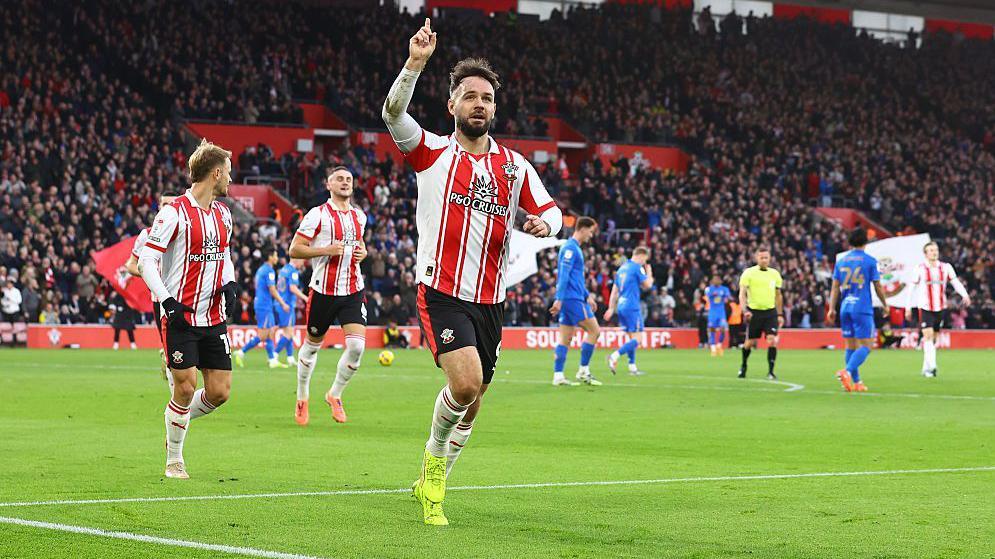 Adam Armstrong points to the sky after scoring for Southampton in their game against Birmingham City