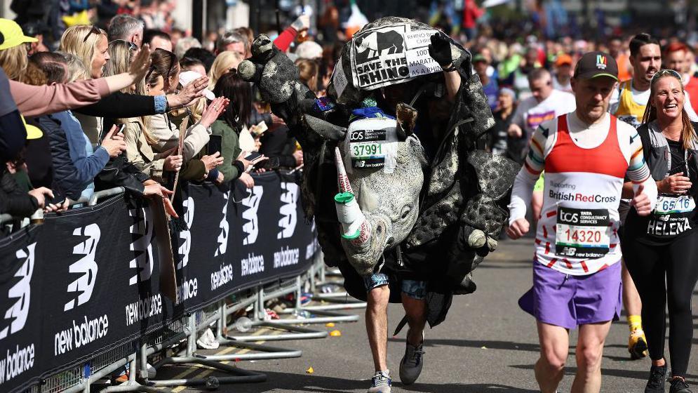 Fun runners, one dressed as a rhinoceros, compete in the 2024 London Marathon