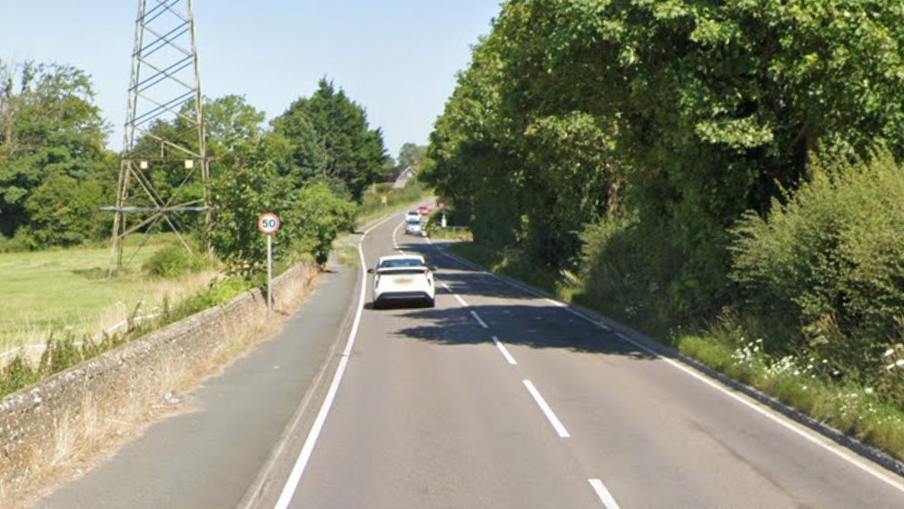 The A26 through Stoneham. It is an A-road with one carriage in each direction and no central reservation. There is a 50mph sign on the left and a white car in front