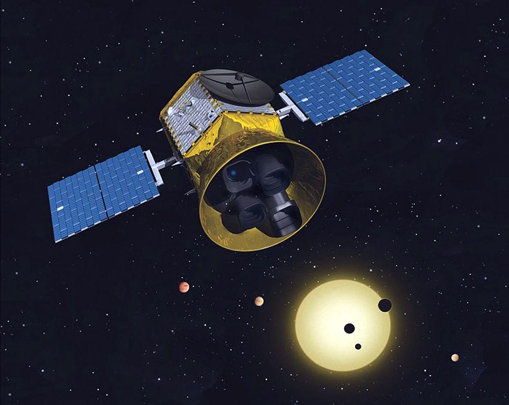 An image of a satellite and a solar system in the distance. 