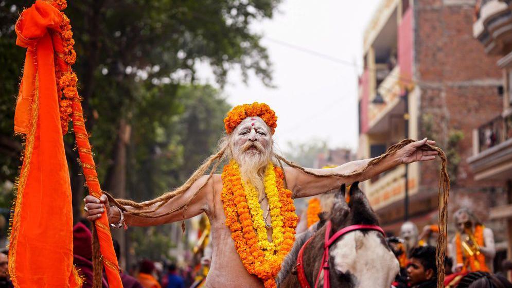 A Sadhu, or Hindu holy man, rides a horse during a religious procession of the Mahanirvani Akhada, ahead of the Maha Kumbh Mela festival in Prayagraj on January 2, 2025. (Photo by HIMANSHU SHARMA / AFP) (Photo by HIMANSHU SHARMA/AFP via Getty Images)