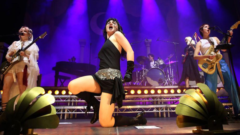 (L-R) Emily Roberts, Abigail Morris and Lizzie Mayland of The Last Dinner Party perform during a concert at Uber Eats Music Hall on November 07, 2024 in Berlin, Germany. 