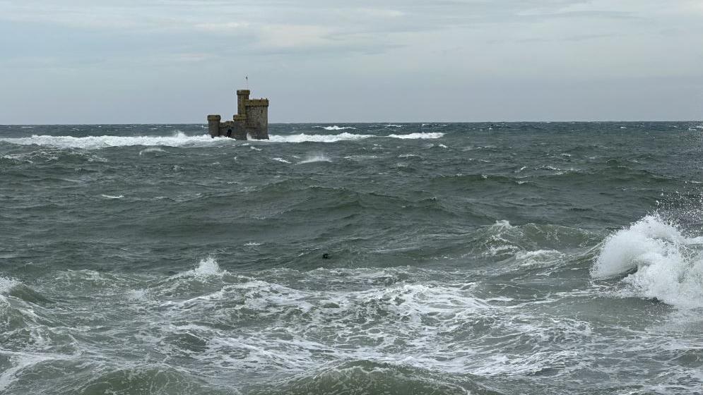 Choppy seas around the Tower of Refuge, which is a small castle-like stone structure, in Douglas Bay.